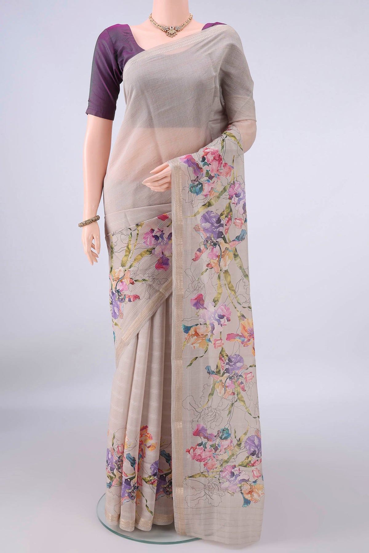 Beige Chanderi Cotton Saree with Floral Print on the body and Zari Border.  displayed on a mannequin