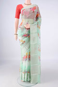 Pure Silk Light Green Kota Saree with Floral Print on the body and Zari Border.  displayed on a mannequin
