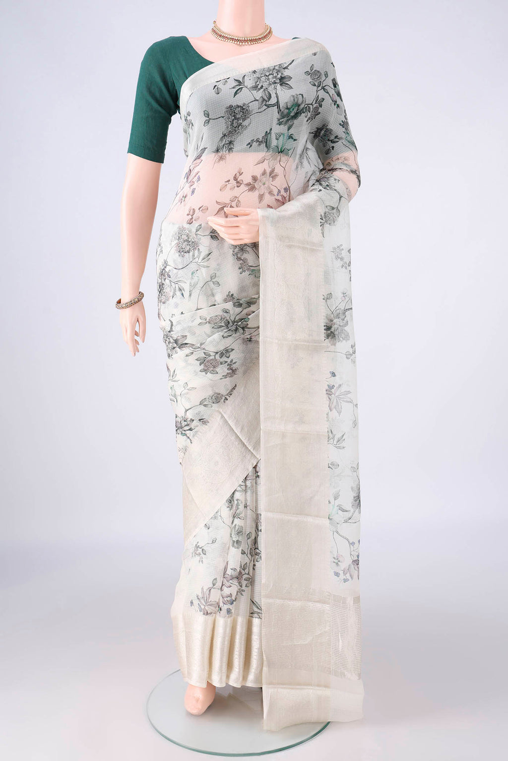 Pure Silk Off White Kota Saree with Floral Print on the body and Zari Border.  displayed on a mannequin