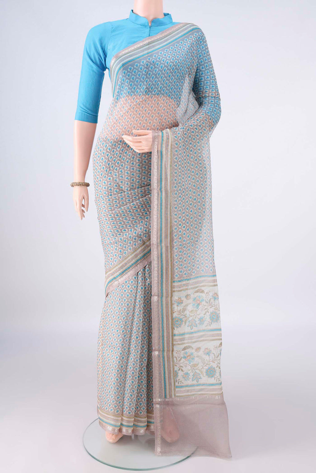 Pure Silk Grey Kota Saree with Printed design on the body and Zari Border.  displayed on a mannequin