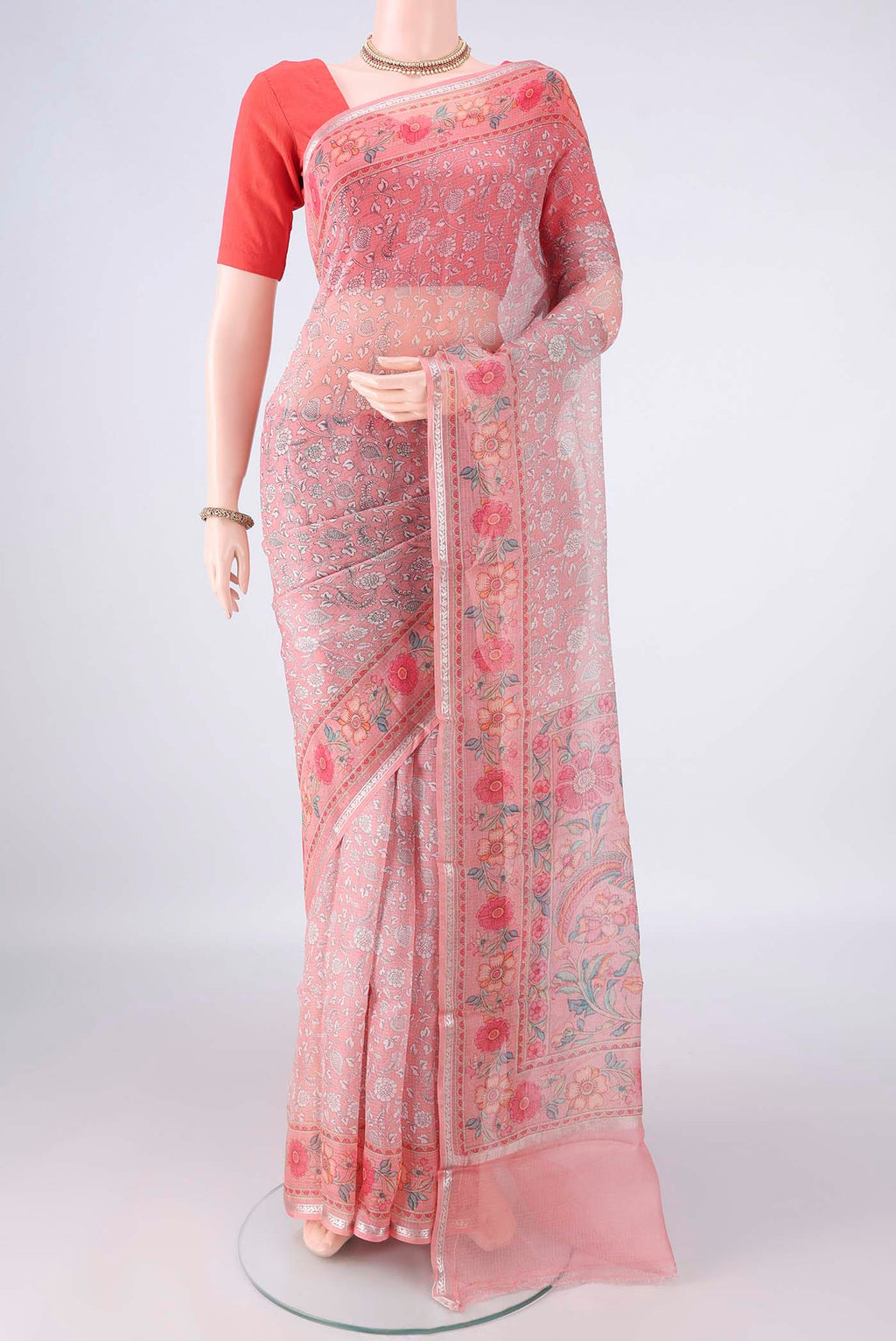 Pure Silk Peach Kota Saree with Printed design on the body and Zari Border.  displayed on a mannequin