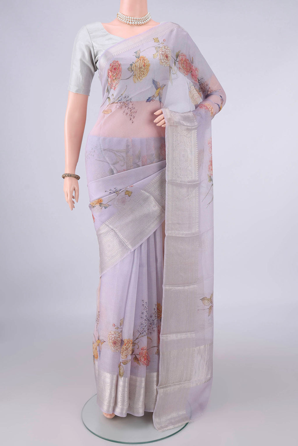Pure Silk Lilac Kota Saree with Floral Print on the body and Zari Border.  displayed on a mannequin