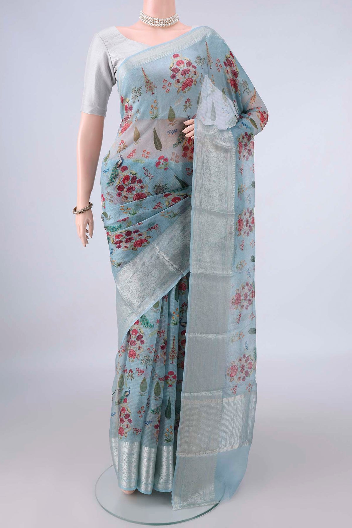 Pure Silk Sky Blue Kota Saree with Floral Print on the body and Zari Border.  displayed on a mannequin