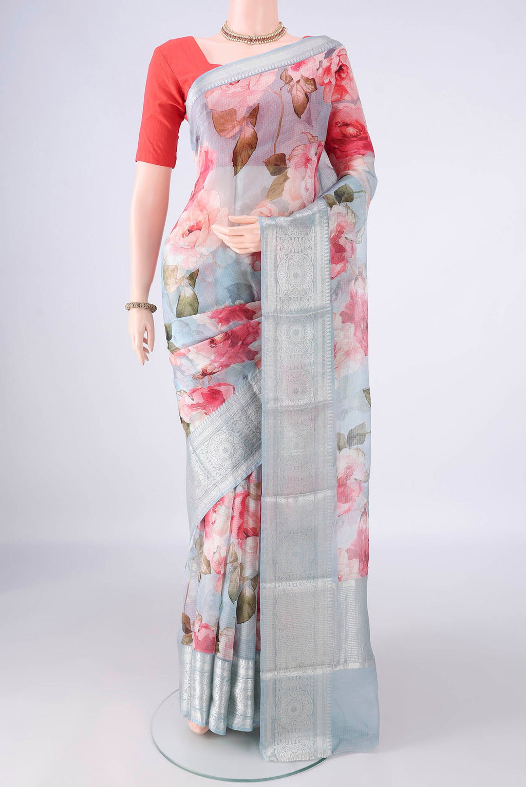 Pure Silk Light Blue Kota Saree with Printed design on the body and Zari Border.  displayed on a mannequin
