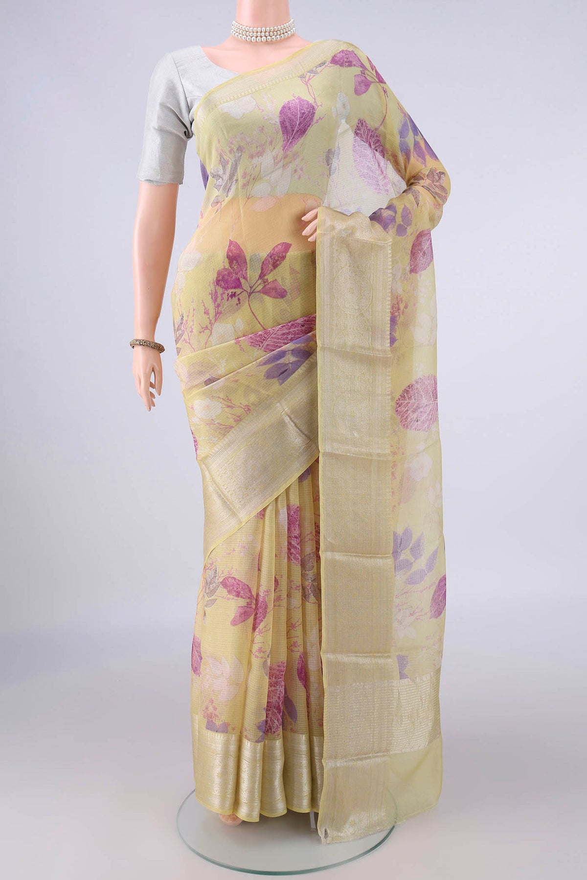 Pure Silk Lemon Yellow Kota Saree with Floral Print on the body and Zari Border.  displayed on a mannequin