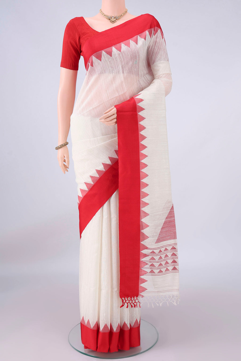 Pure Silk White Jute Saree with Jamdani on the body and Temple Border.  displayed on a mannequin