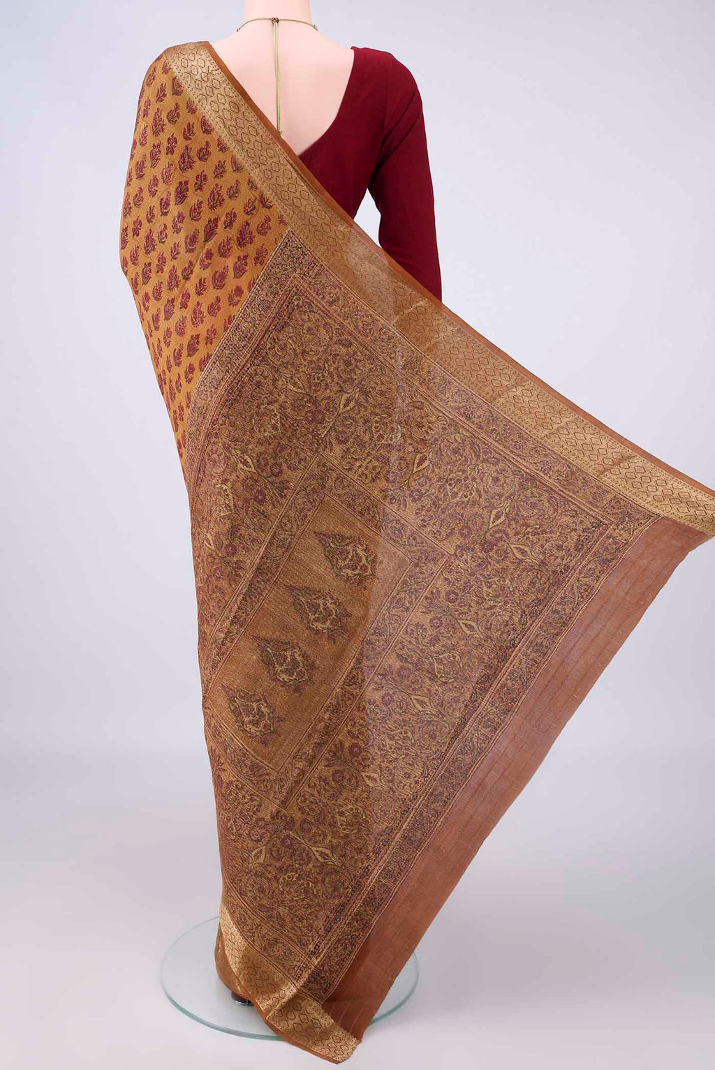 Flat view of Mustard Mysore Crepe Saree with Printed design on the body and Zari Border. 