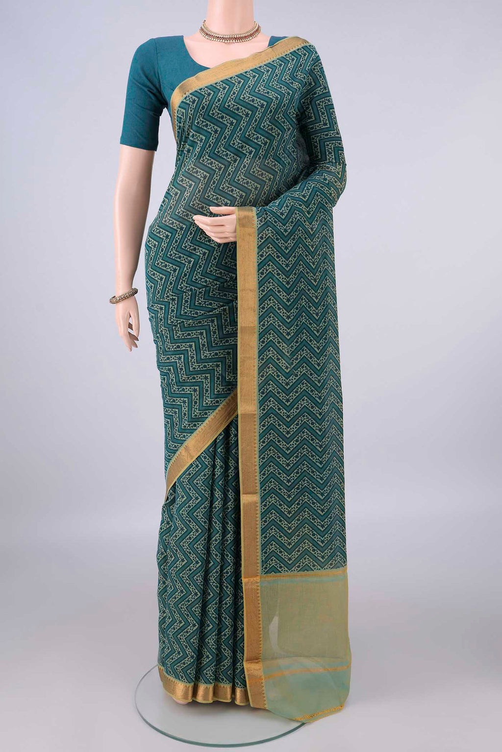 Green Mangalagiri Cotton Saree with Printed design on the body and Zari Border.  displayed on a mannequin