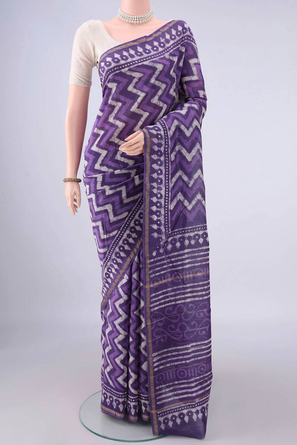 Lilac Chanderi Cotton Saree with Batik Print on the body and Thin Zari Line.  displayed on a mannequin