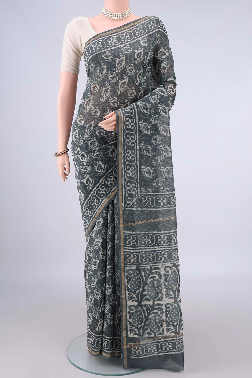 Grey Chanderi Cotton Saree with Batik Print on the body and Thin Zari Line.  displayed on a mannequin