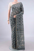Grey Chanderi Cotton Saree with Batik Print on the body and Thin Zari Line.  displayed on a mannequin