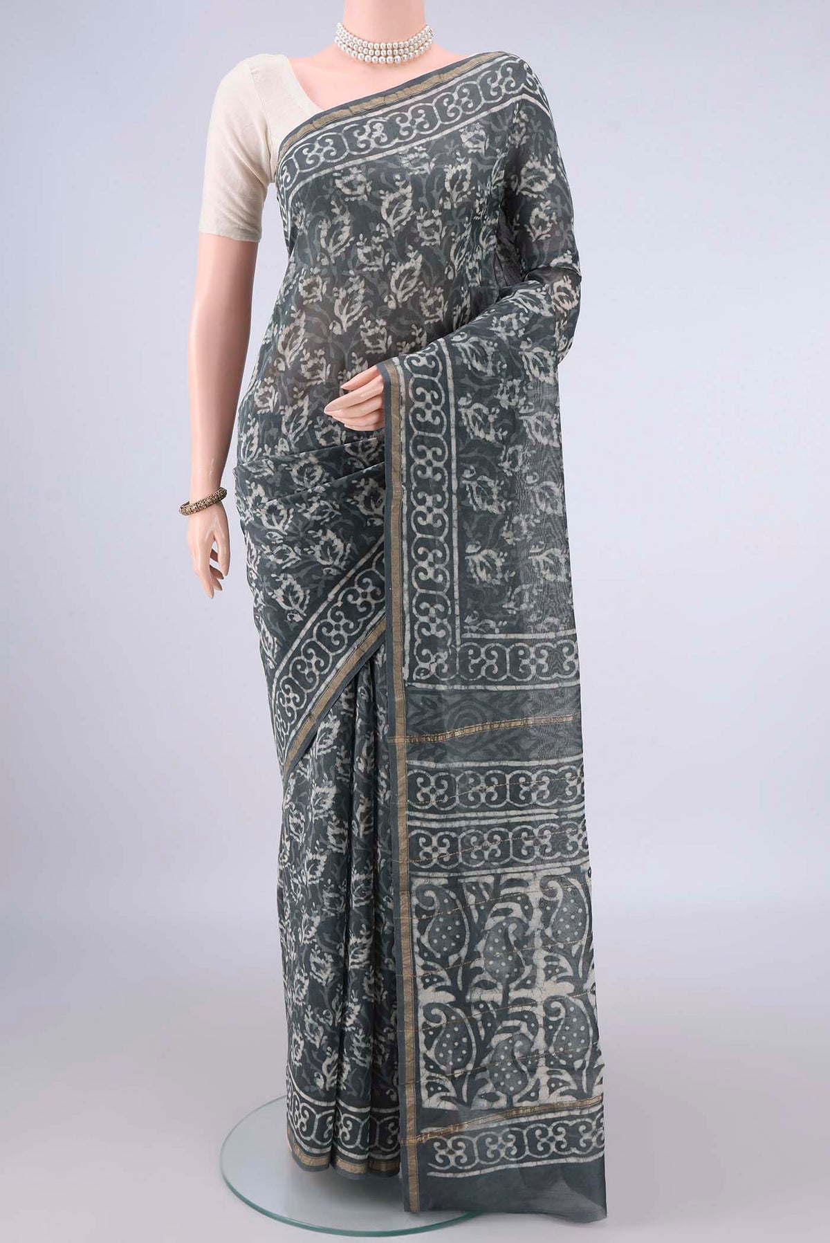 Grey Chanderi Cotton Saree with Batik Print on the body and Thin Zari Line.  displayed on a mannequin