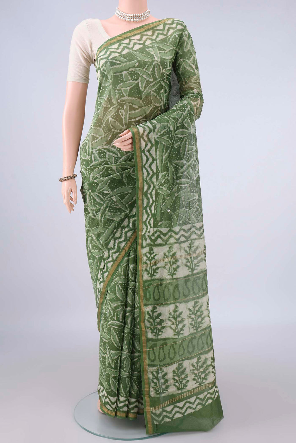 Mehandi Green Chanderi Cotton Saree with Batik Print on the body and Thin Zari Line.  displayed on a mannequin