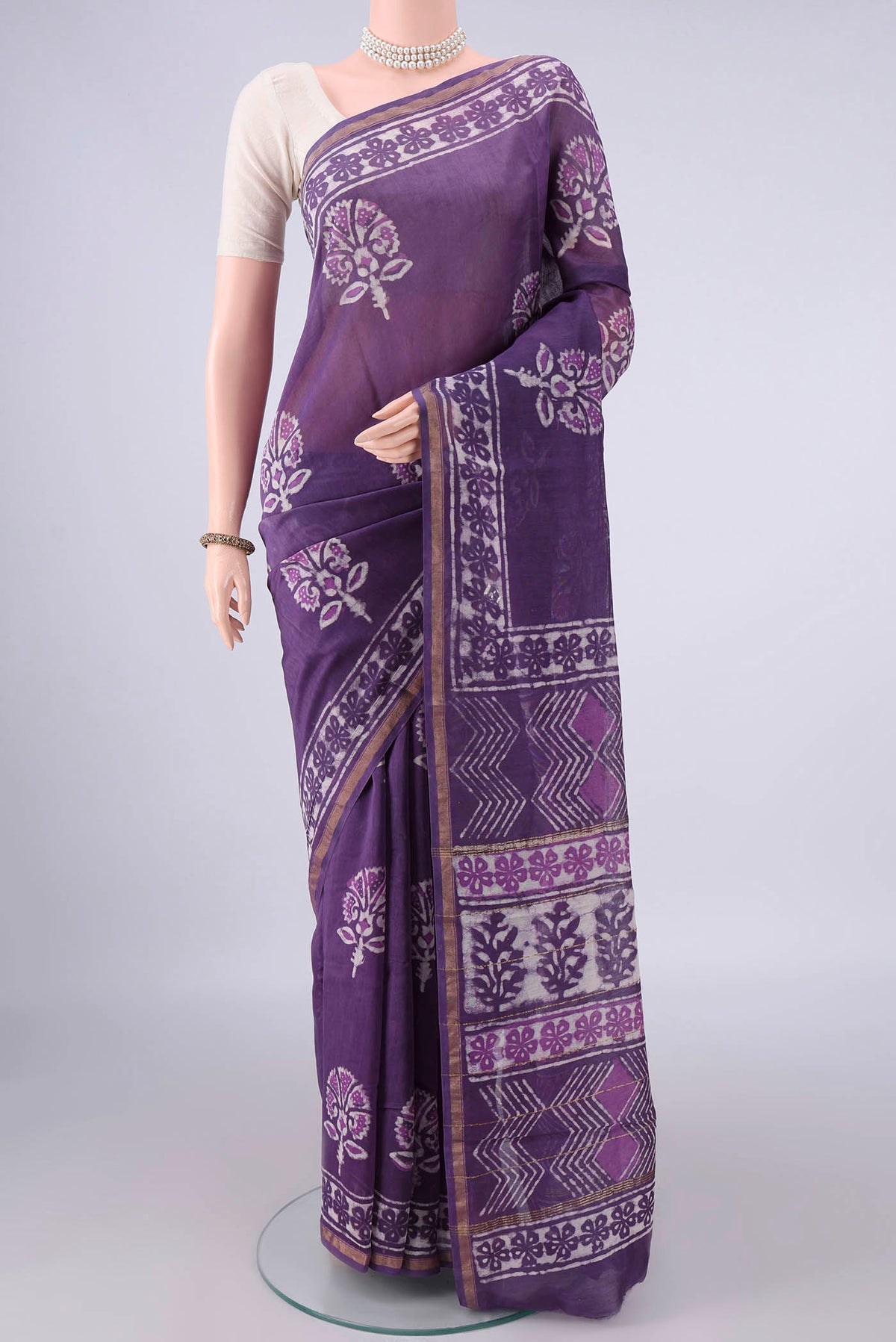 Purple Chanderi Cotton Saree with Batik Print on the body and Thin Zari Line.  displayed on a mannequin