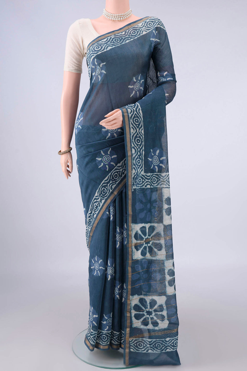 Blue Grey Chanderi Cotton Saree with Batik Print on the body and Thin Zari Line.  displayed on a mannequin