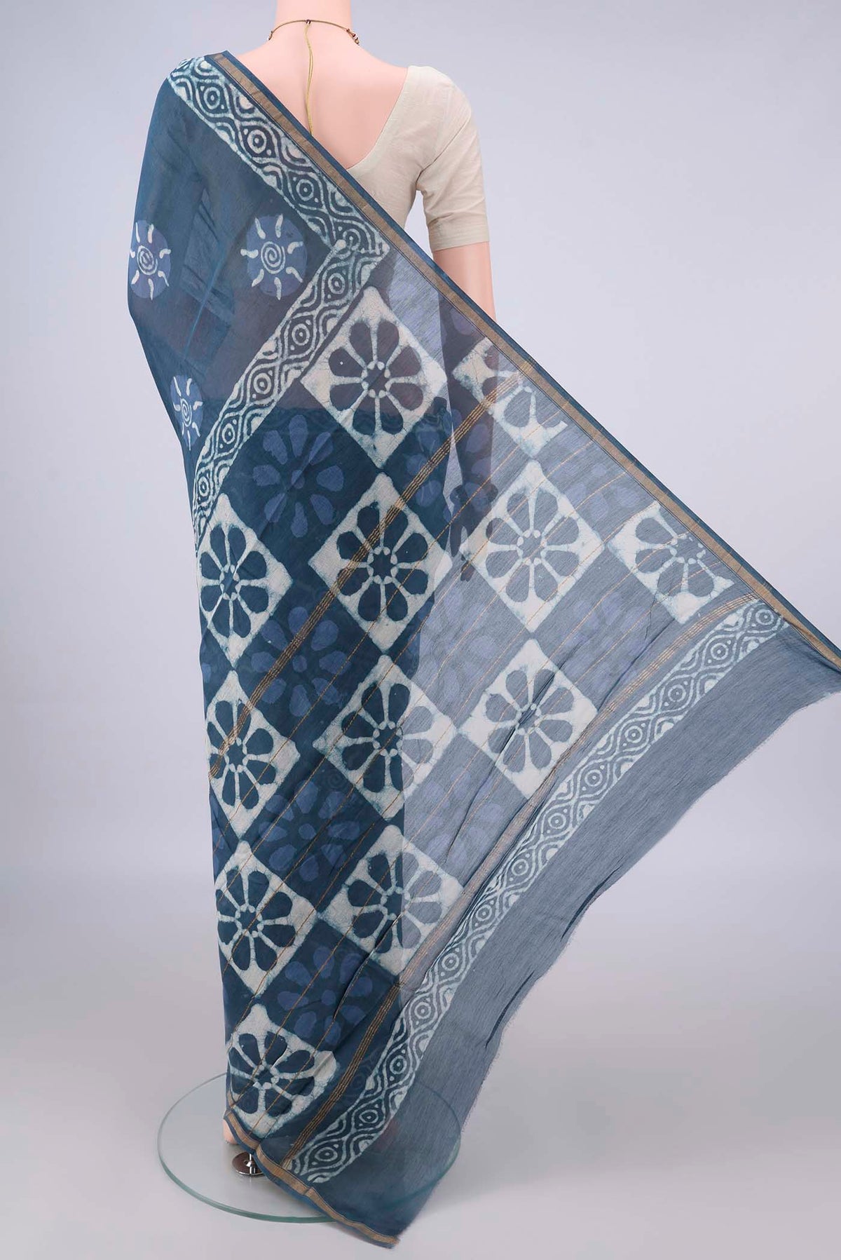 Flat view of Blue Grey Chanderi Cotton Saree with Batik Print on the body and Thin Zari Line. 