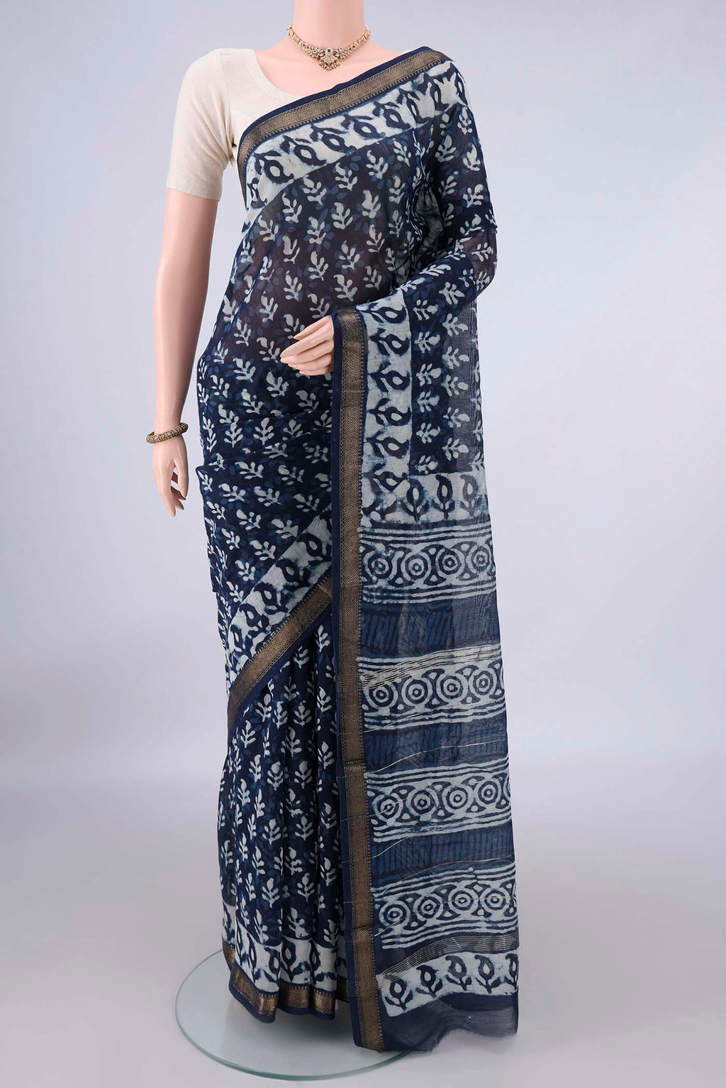 Indigo Maheshwari Cotton Saree with Batik Print on the body and Zari Border.  displayed on a mannequin
