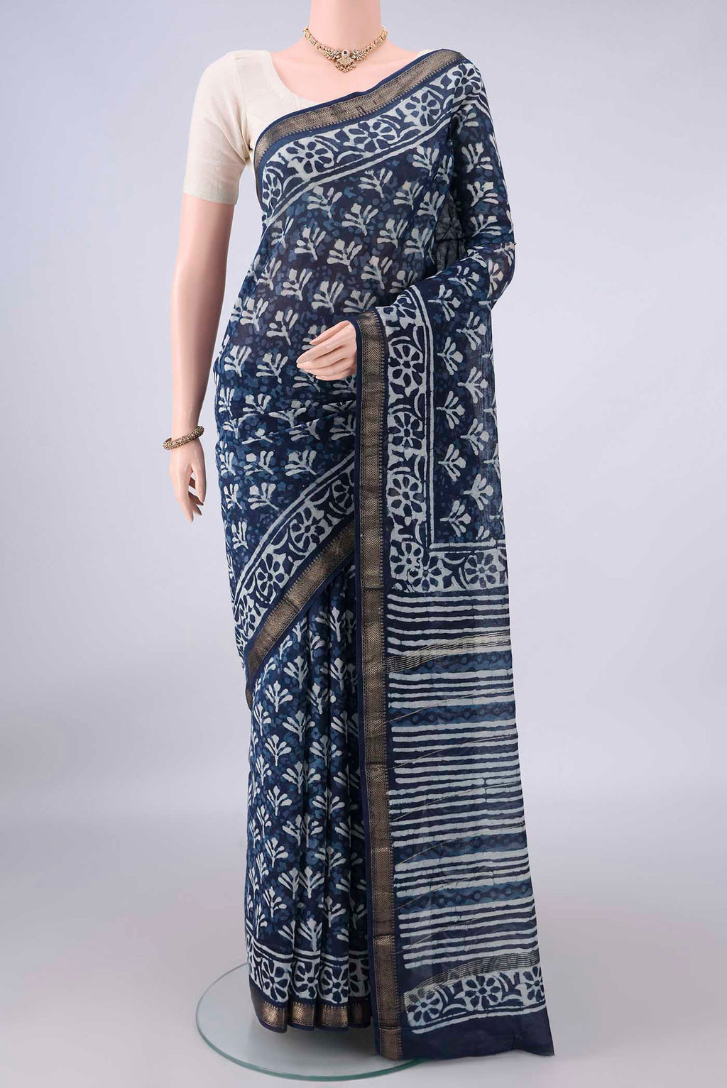 Indigo Maheshwari Cotton Saree with Batik Print on the body and Zari Border.  displayed on a mannequin