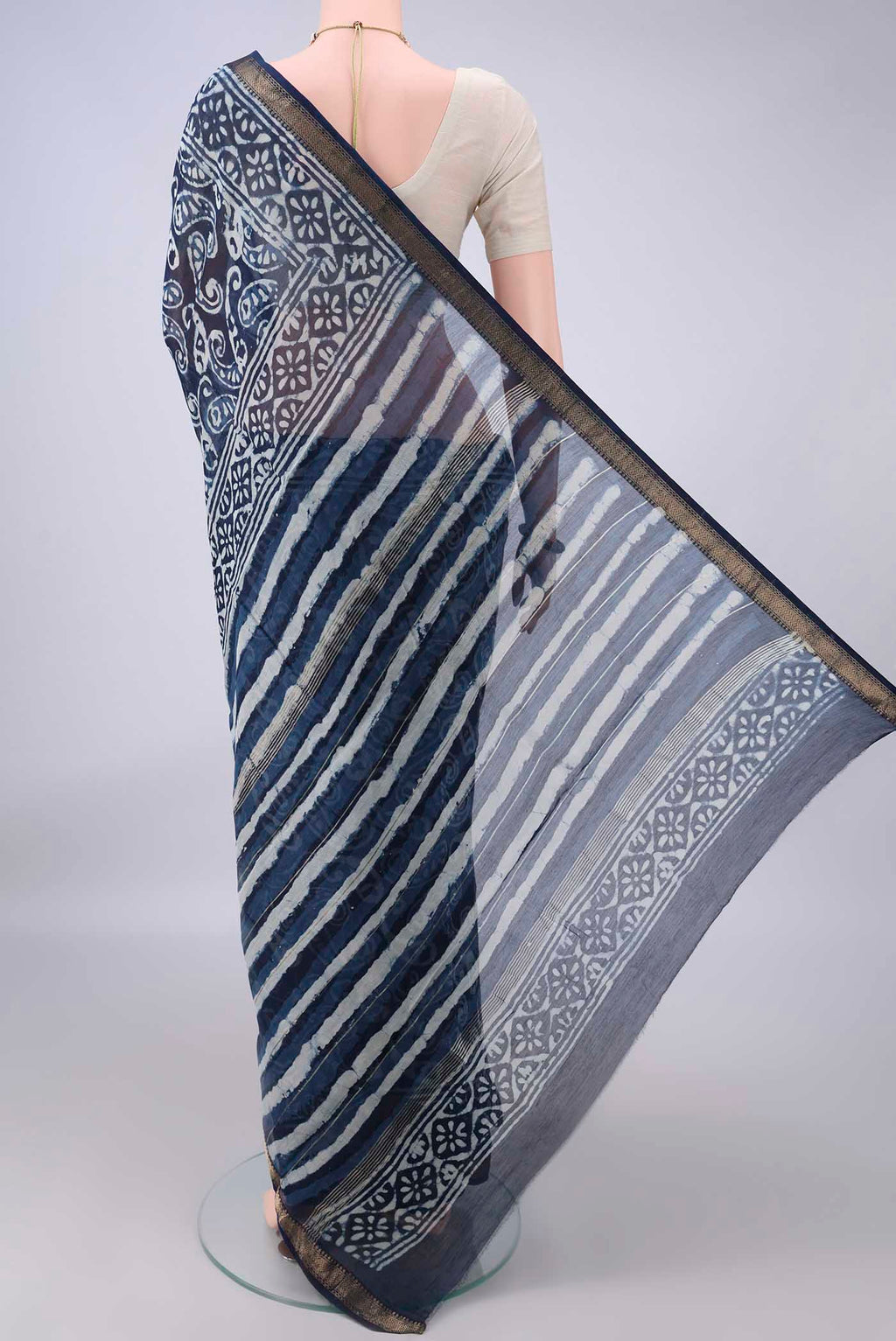 Flat view of Indigo Mangalagiri Cotton Saree with Batik Print on the body and Zari Border. 