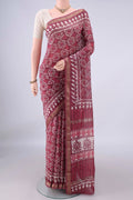 Coral Maheshwari Cotton Saree with Batik Print on the body and Zari Border.  displayed on a mannequin