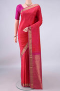 Pure Silk Coral Kanchipuram Saree with Zari Butta on the body and Zari Border.  displayed on a mannequin
