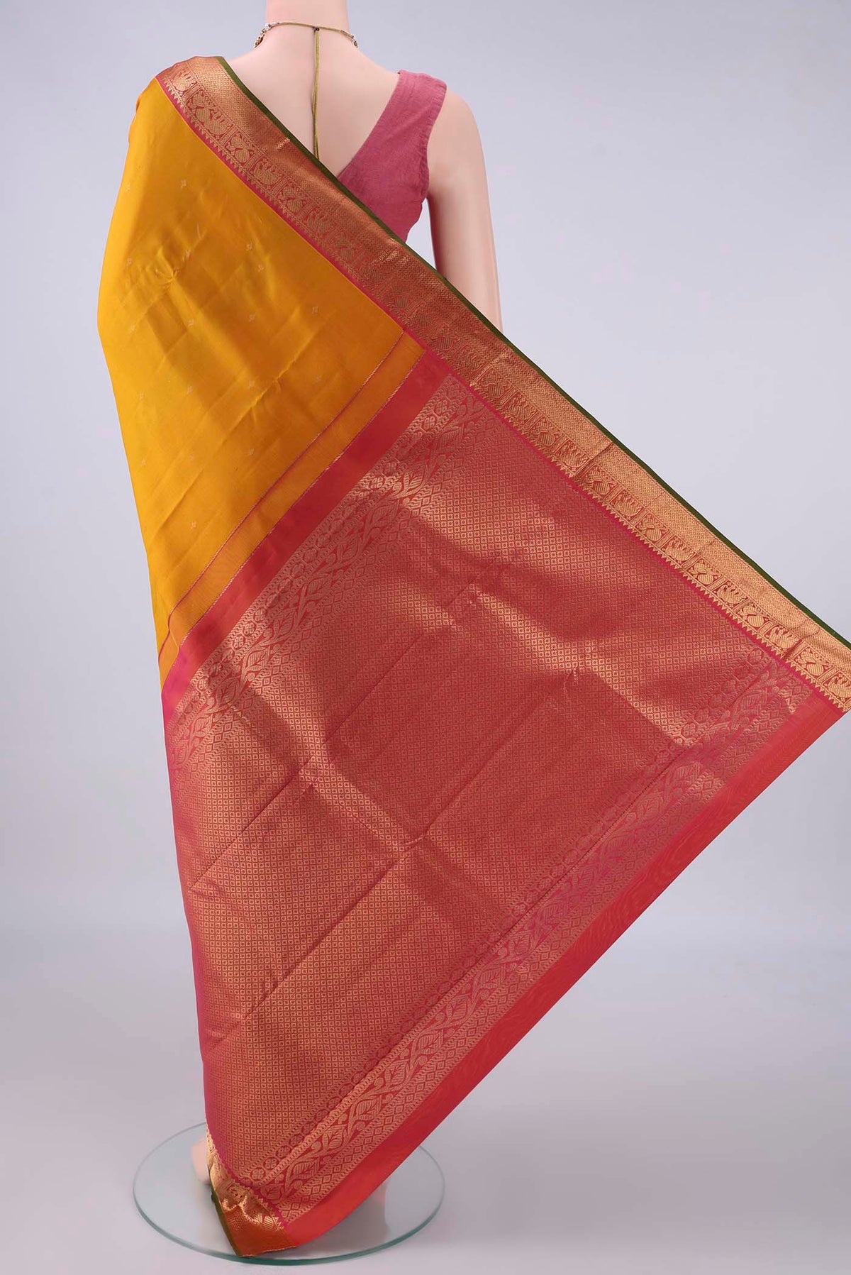 Flat view of Pure Silk Mustard Kanchipuram Saree with Zari Butta on the body and Zari Border. 