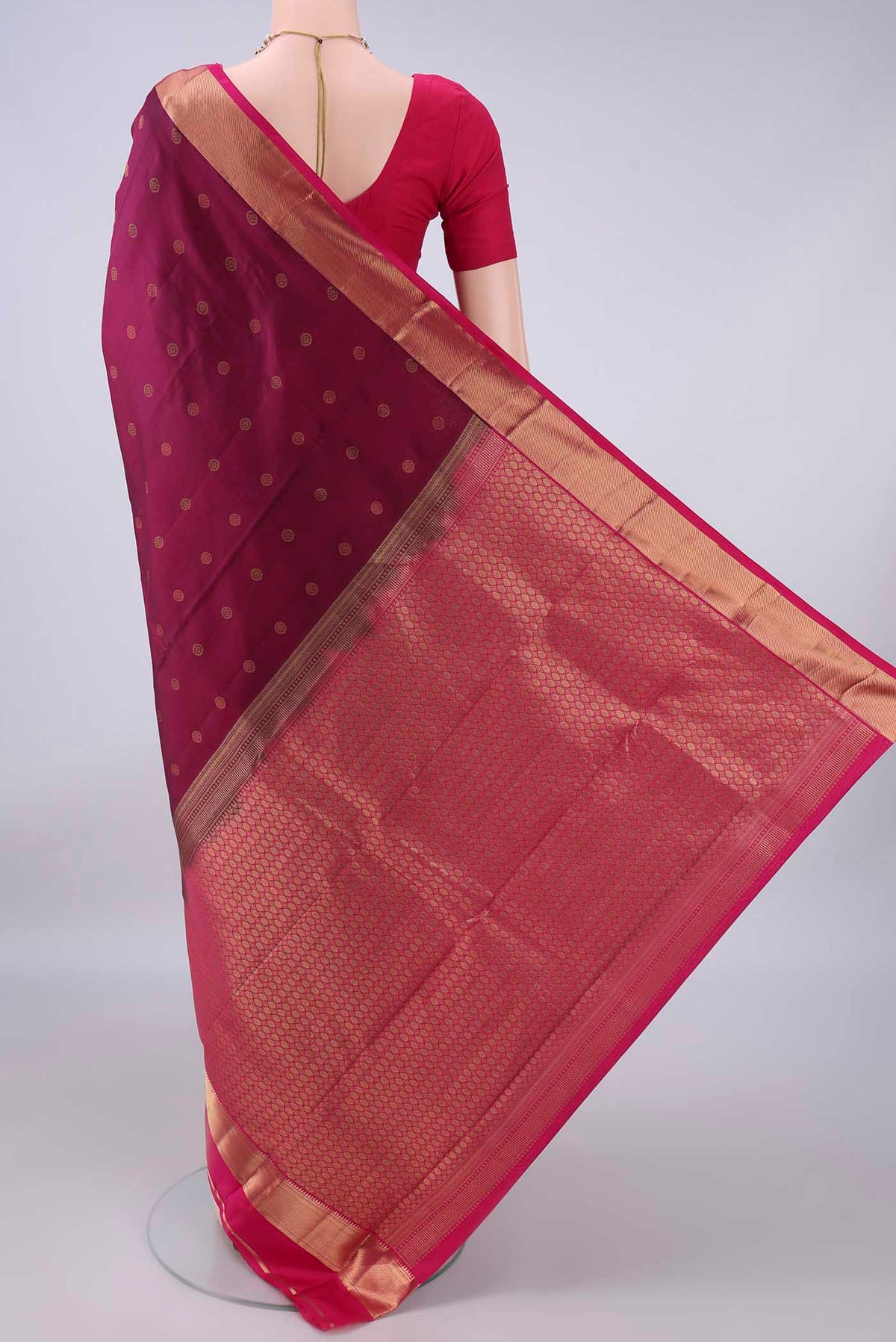 Flat view of Pure Silk Burgundy Kanchipuram Saree with Zari Butta on the body and Zari Border. 