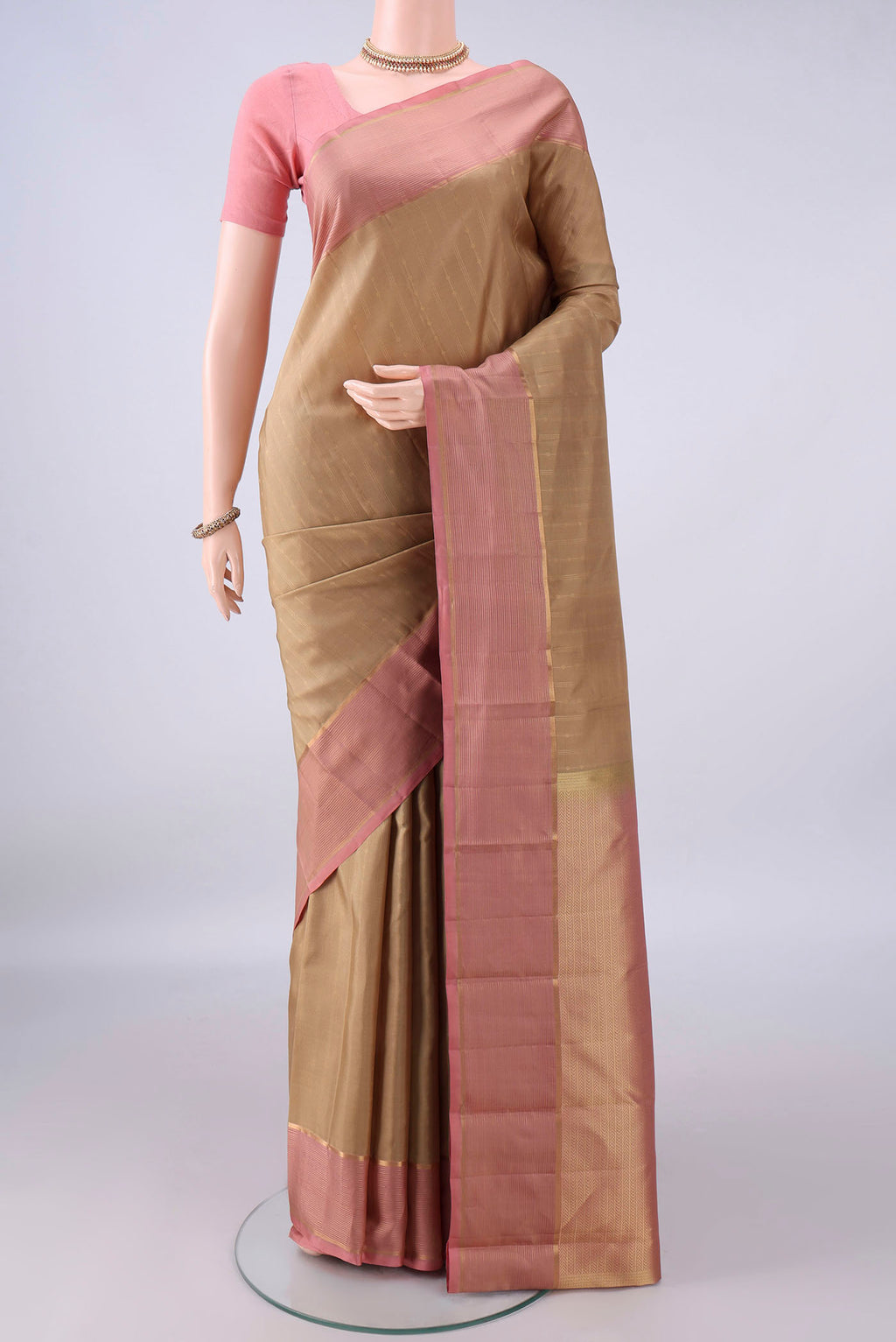 Pure Silk Dark Beige Kanchipuram Saree with Stripes on the body and Zari Border.  displayed on a mannequin