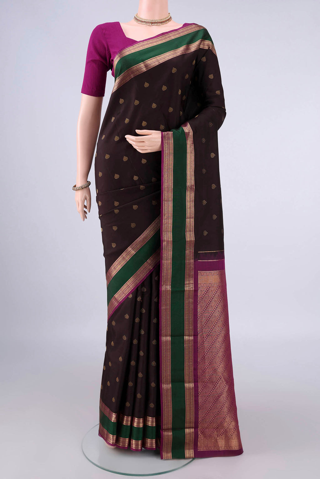 Pure Silk Coffee Brown Kanchipuram Saree with Zari Butta on the body and Zari Border.  displayed on a mannequin