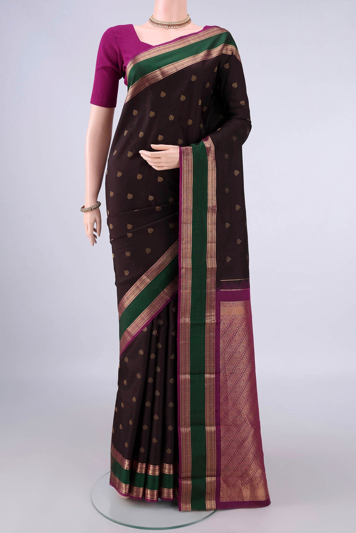 Pure Silk Coffee Brown Kanchipuram Saree with Zari Butta on the body and Zari Border.  displayed on a mannequin