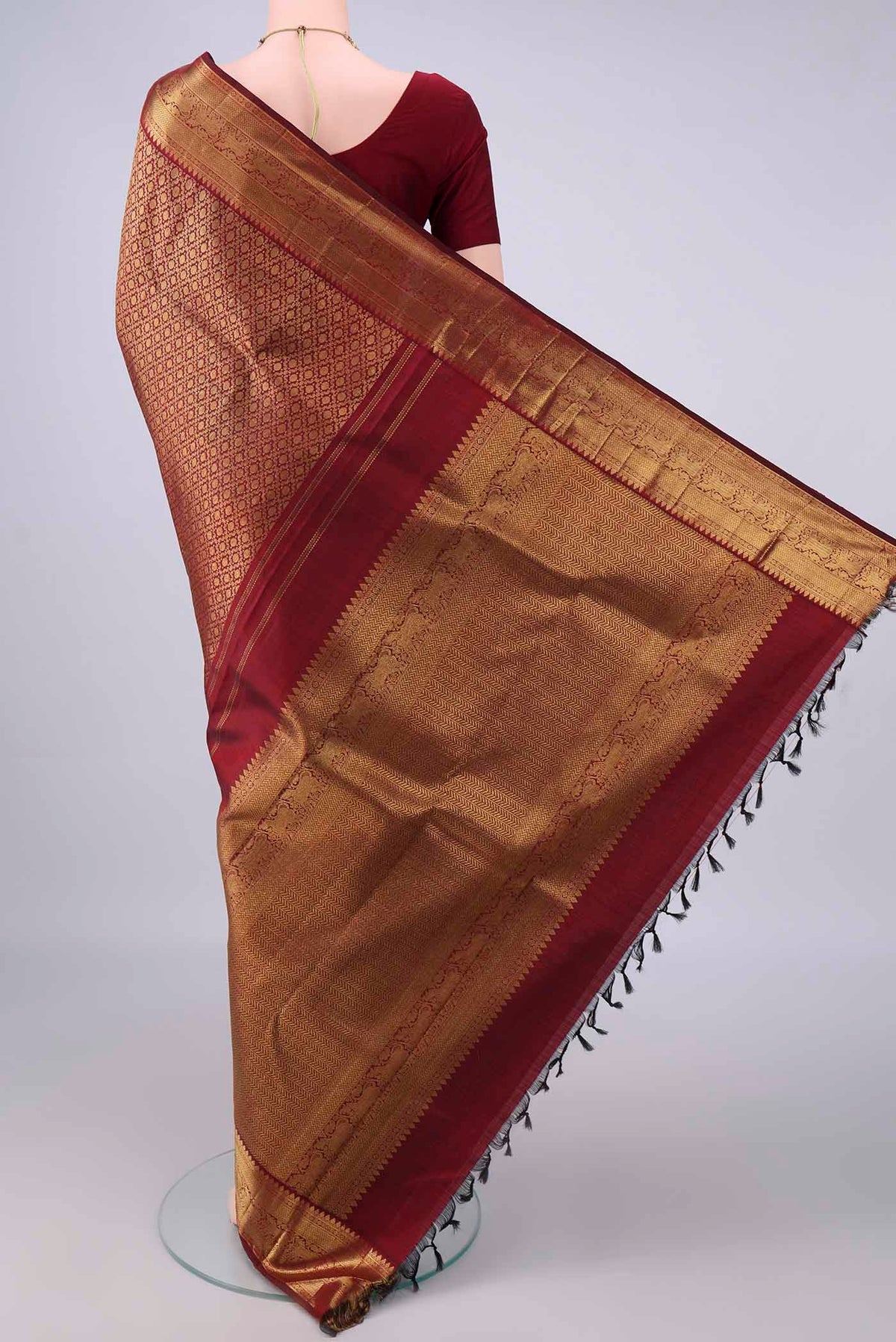 Flat view of Pure Silk Maroon Kanchipuram Saree with Zari Brocade on the body and Zari Border. 