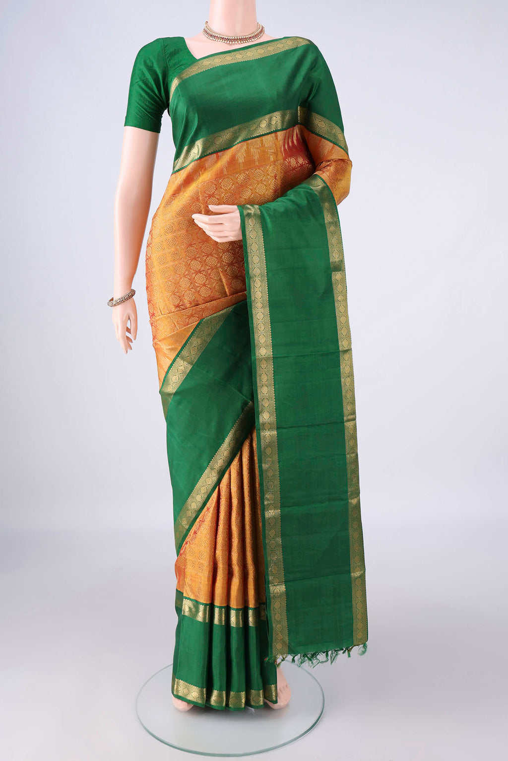 Pure Silk Pure Zari Mustard Kanjivaram Saree with Jacquard design on the body and Zari Border.  displayed on a mannequin
