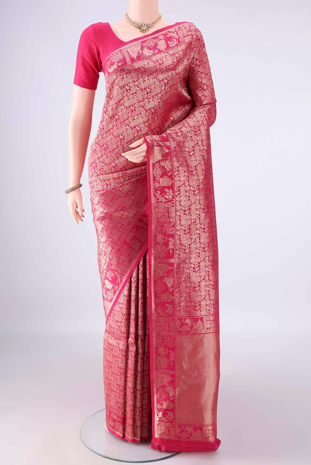 Pure Silk Rani Pink Banarasi Saree with Zari Brocade on the body and Zari Border.  displayed on a mannequin
