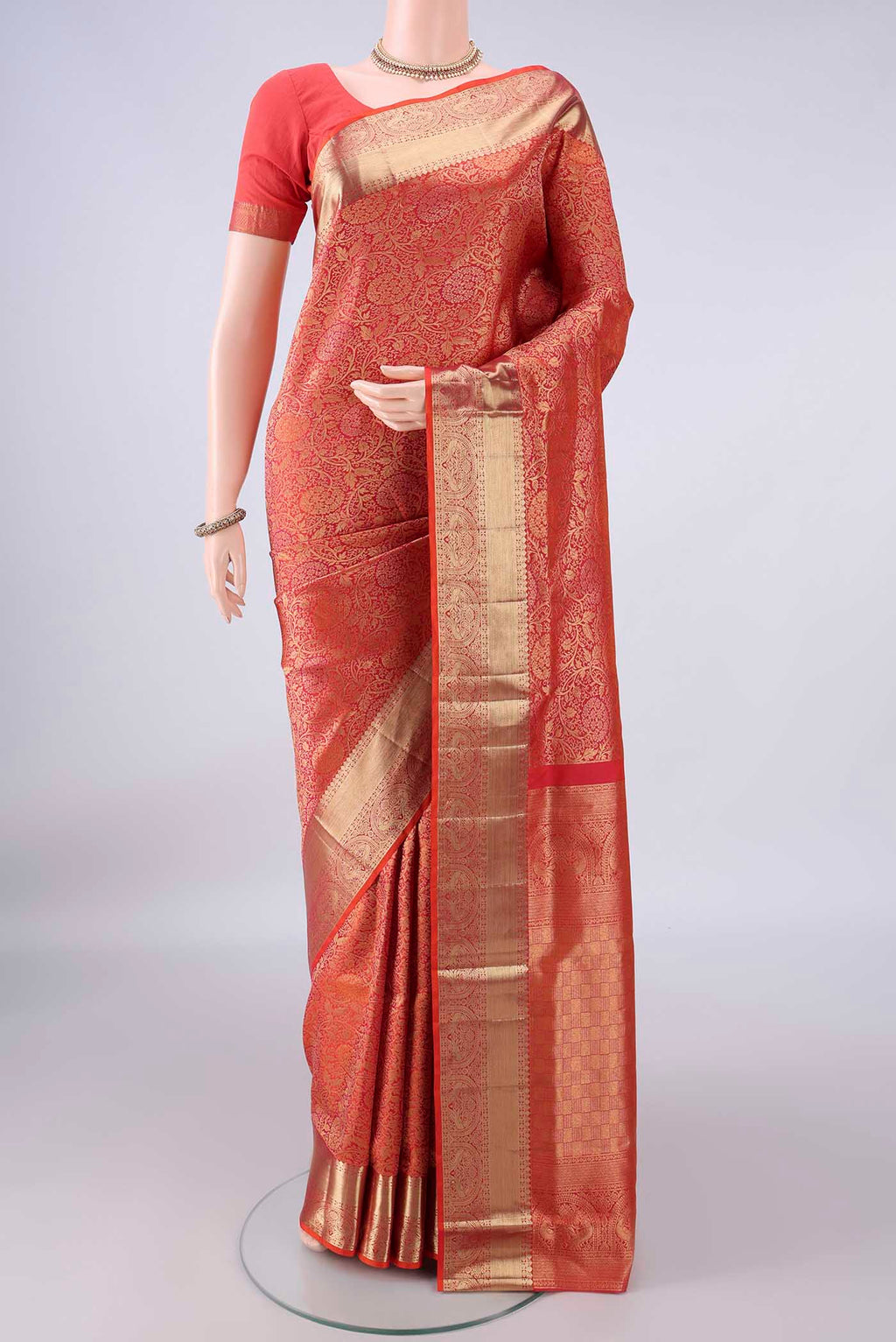 Pure Silk Brick Orange Soft Saree with Zari Brocade on the body and Zari Border.  displayed on a mannequin