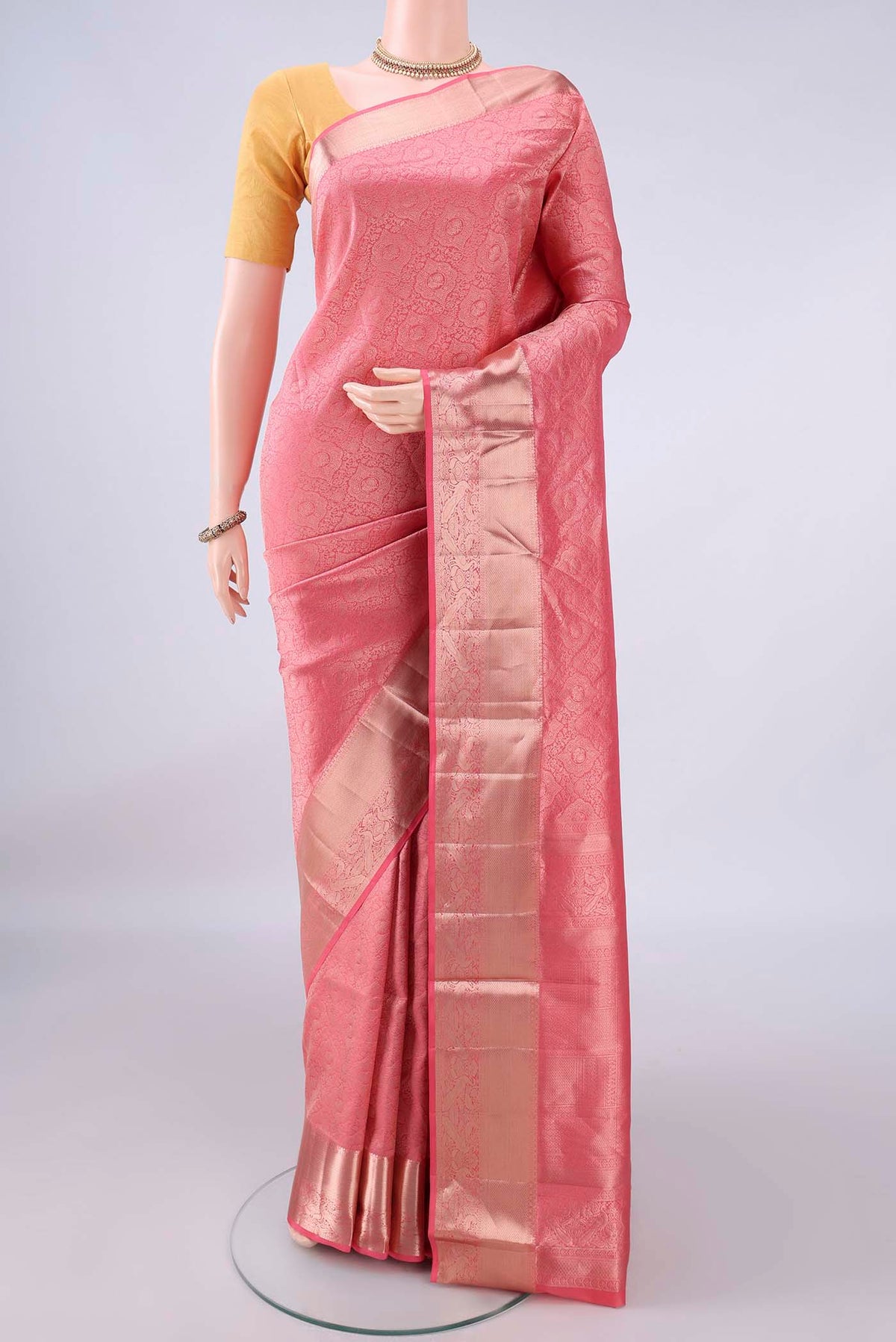 Pure Silk Peach Soft Saree with Zari Brocade on the body and Zari Border.  displayed on a mannequin