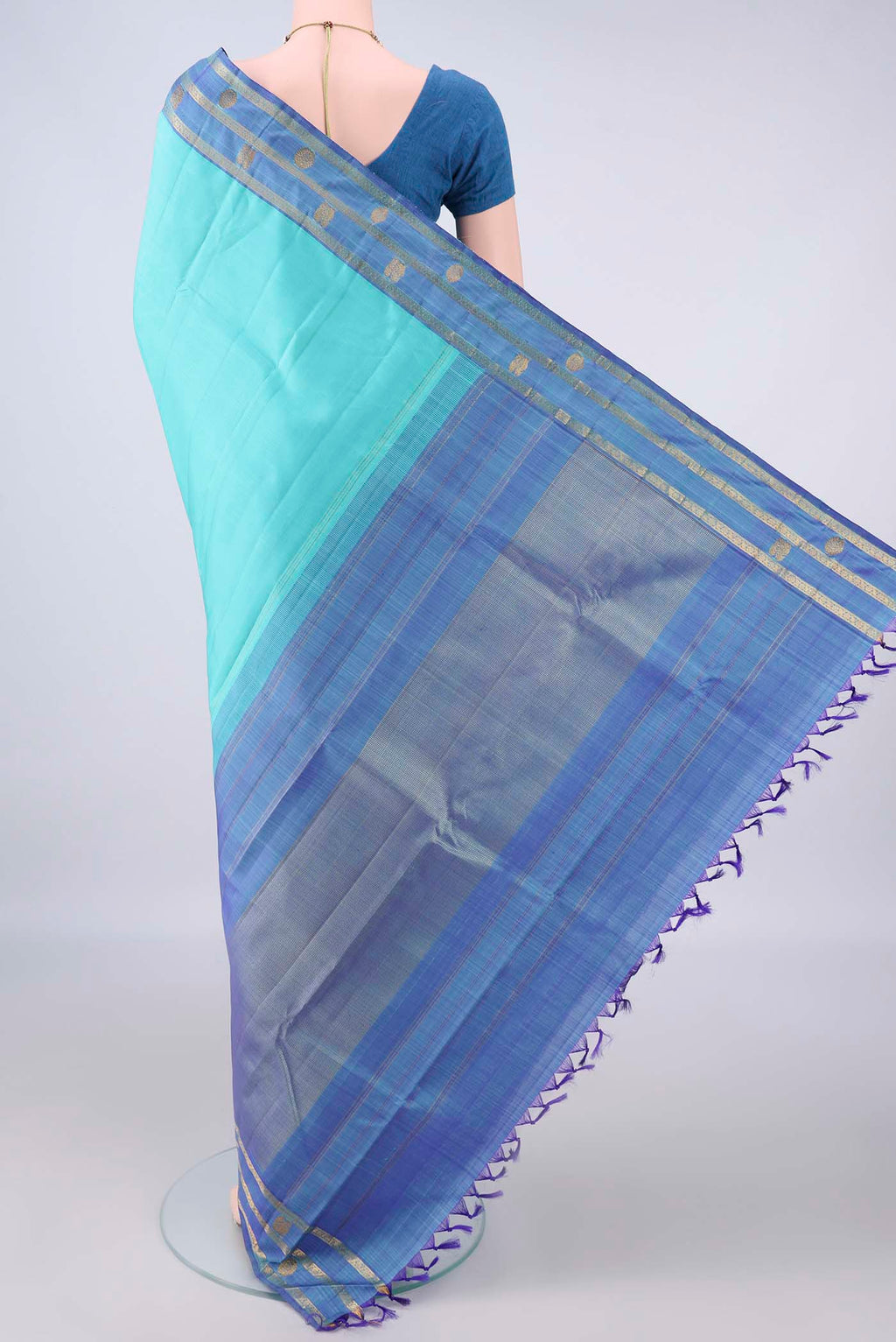 Flat view of Pure Silk Turquoise Kanchipuram Saree with Plain Body and Zari Border. 