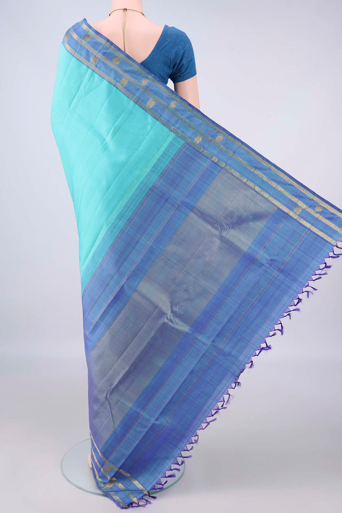 Flat view of Pure Silk Turquoise Kanchipuram Saree with Plain Body and Zari Border. 