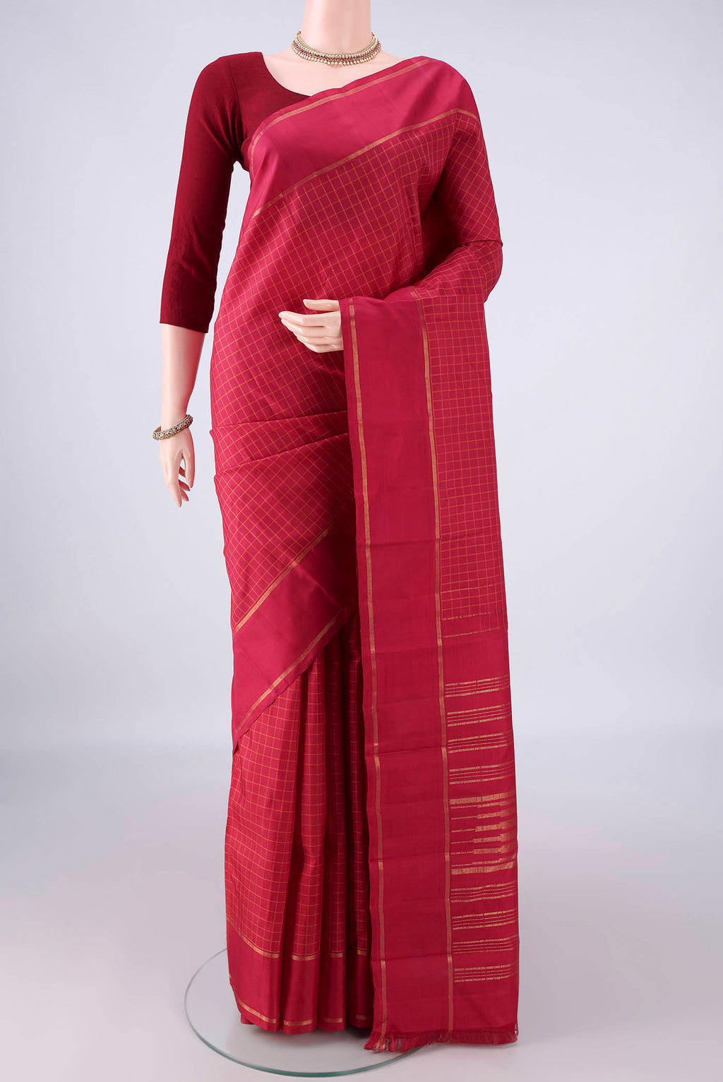 Pure Silk Maroon Kanchipuram Saree with Checked design on the body and Zari Border.  displayed on a mannequin