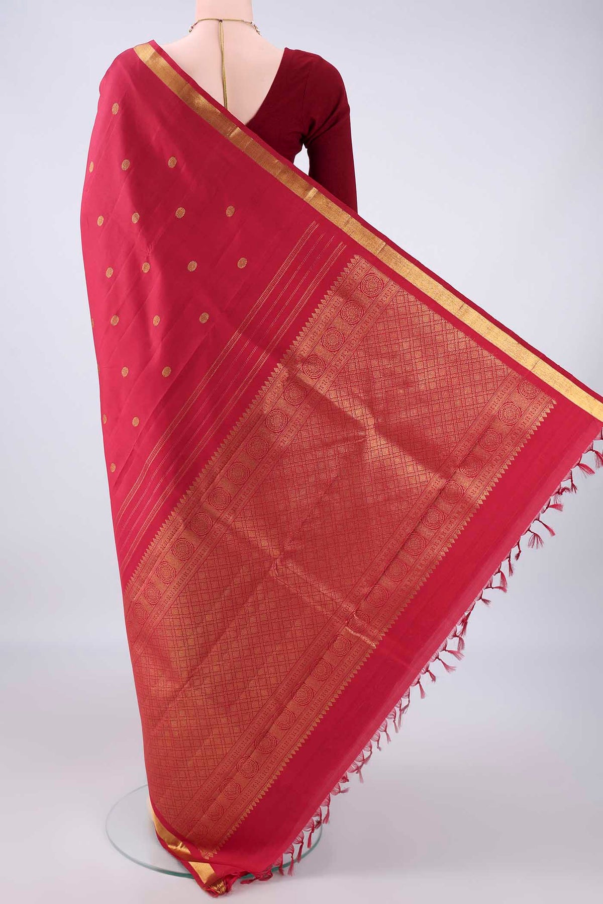 Flat view of Pure Silk Deep Red Kanjivaram Saree with Zari Butta on the body and Zari Border. 