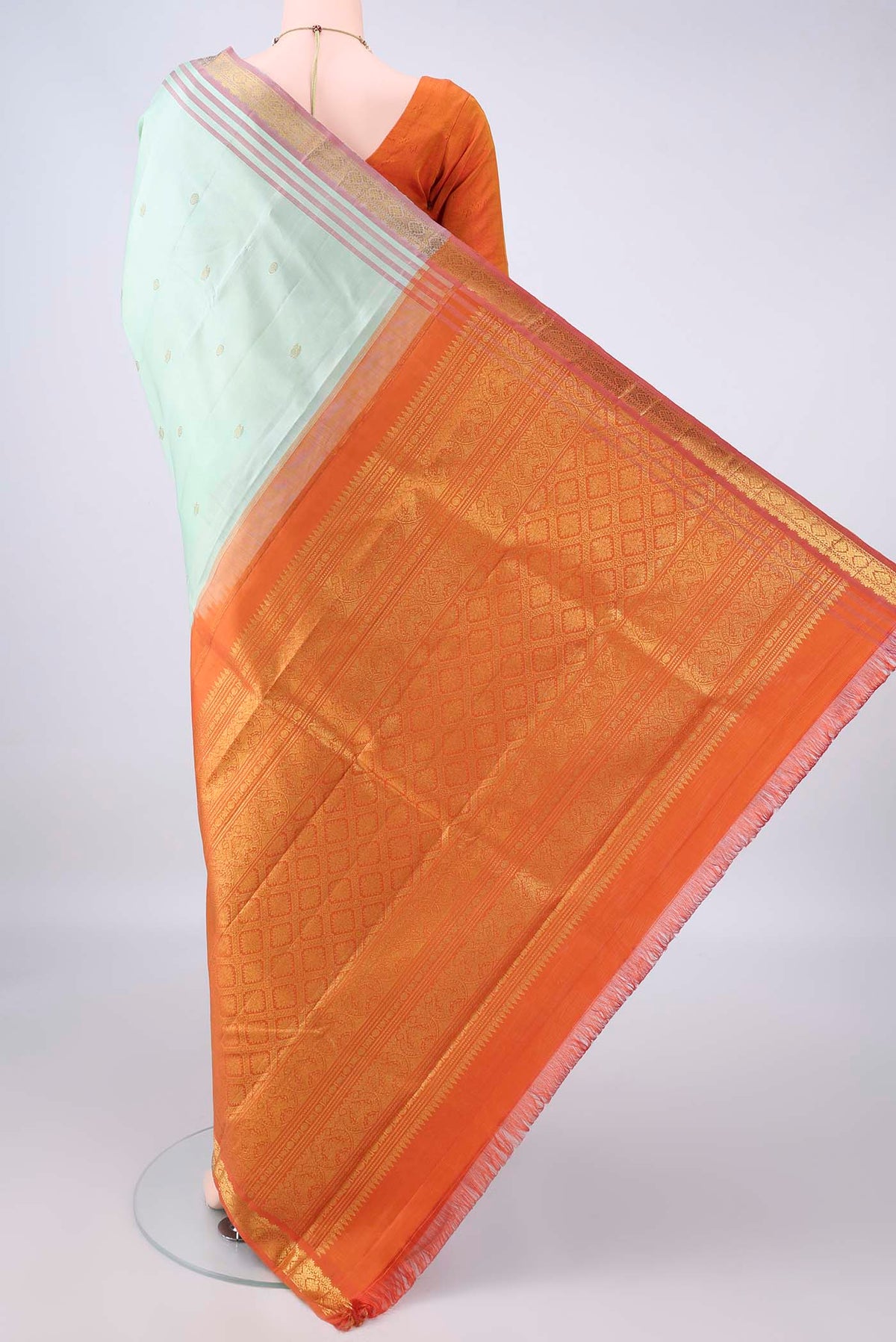 Flat view of Pure Silk Pista Green Kanjivaram Saree with Zari Butta on the body and Zari Border. 