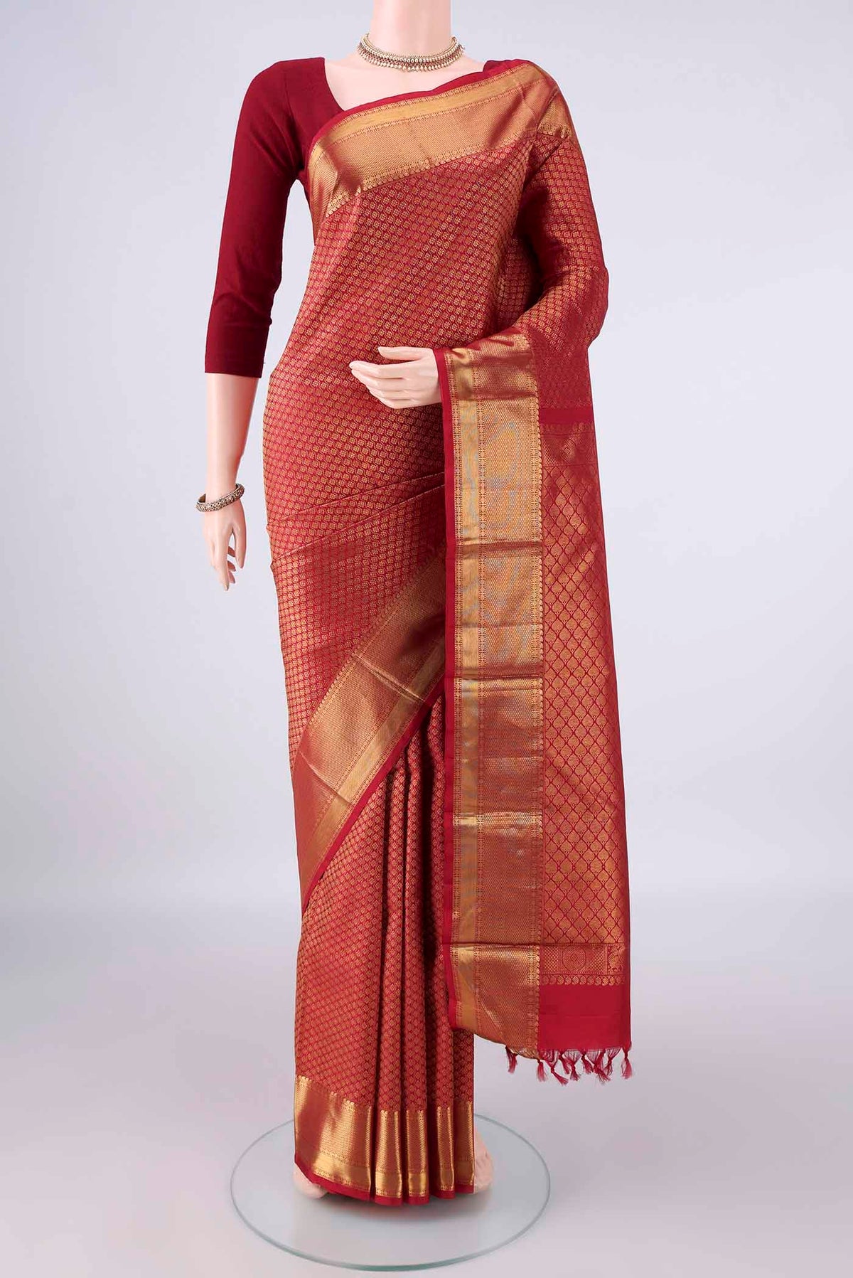 Pure Silk Maroon Kanjivaram Saree with Zari Brocade on the body and Zari Border.  displayed on a mannequin