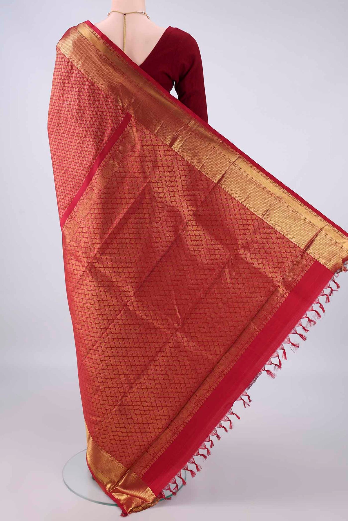 Flat view of Pure Silk Maroon Kanjivaram Saree with Zari Brocade on the body and Zari Border. 
