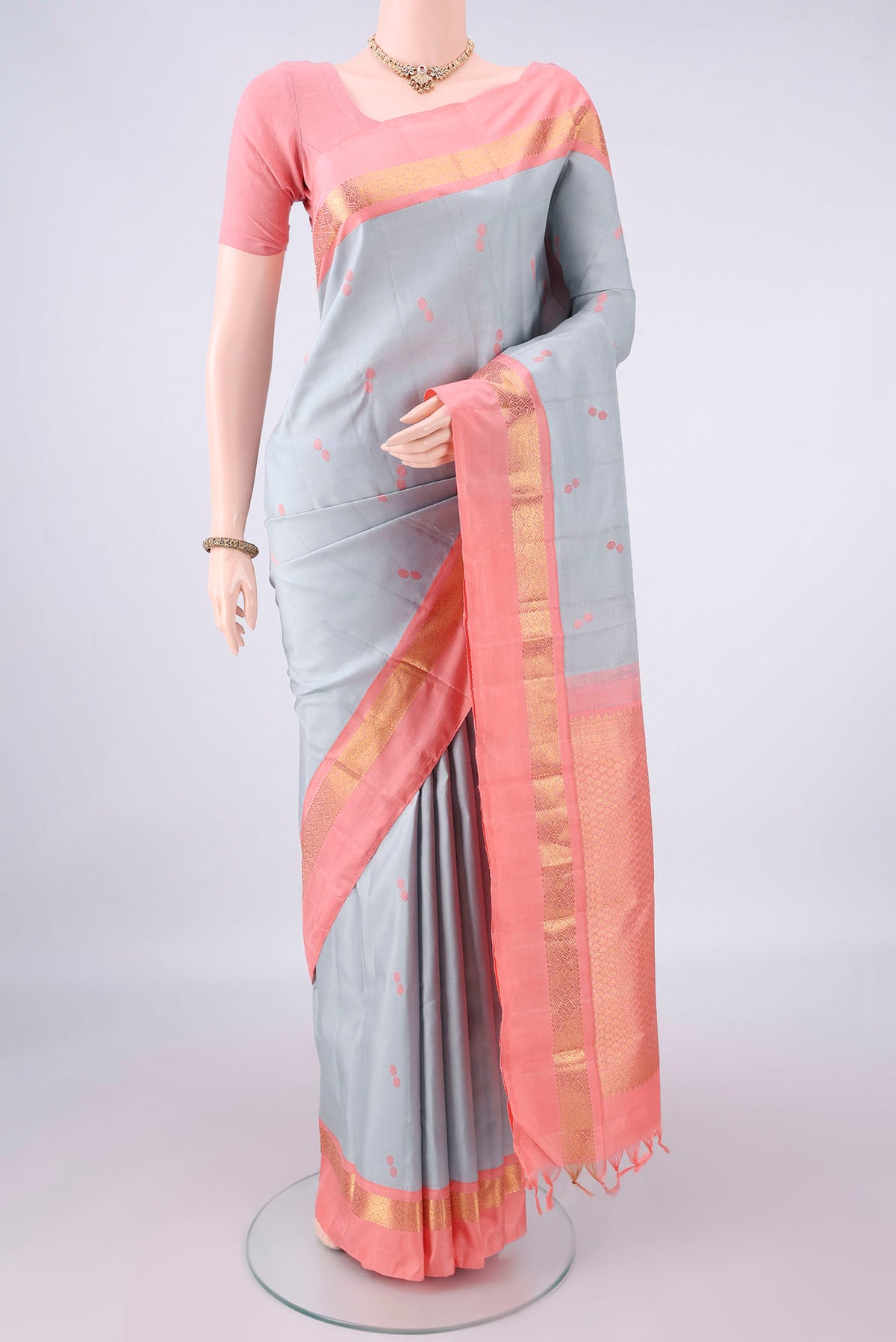 Pure Silk Grey Dual Tone Kanjivaram Saree with Thread Butta on the body and Zari Border.  displayed on a mannequin