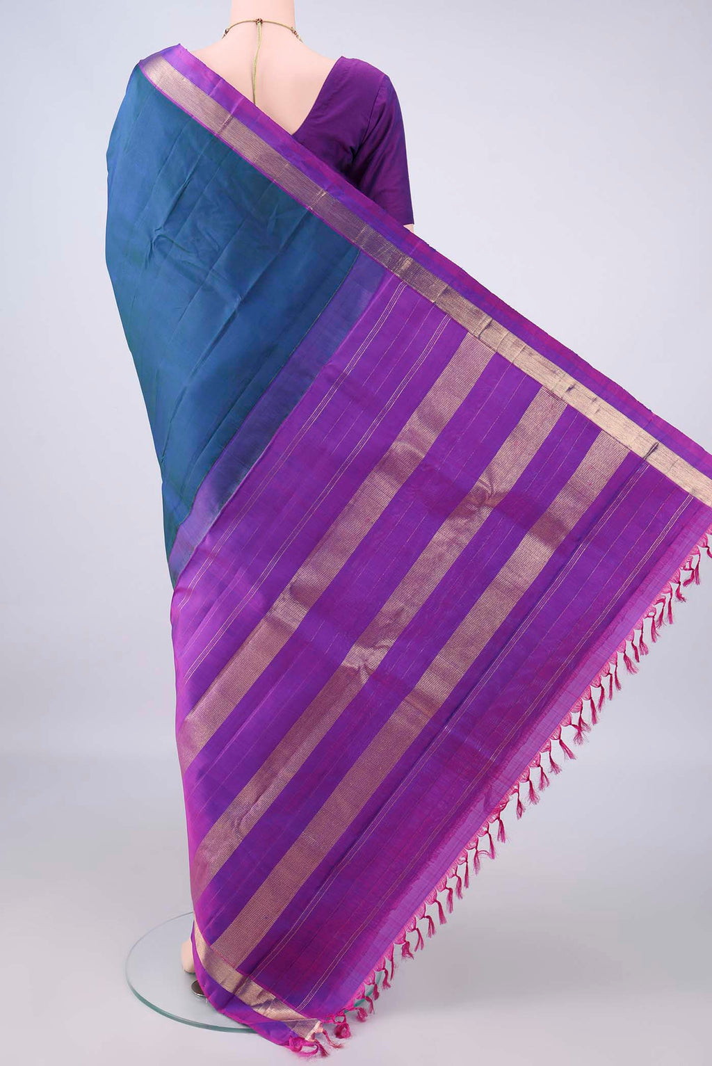 Flat view of Pure Silk Peacock Blue Dual Tone Kanjivaram Saree with Plain Body and Zari Border. 