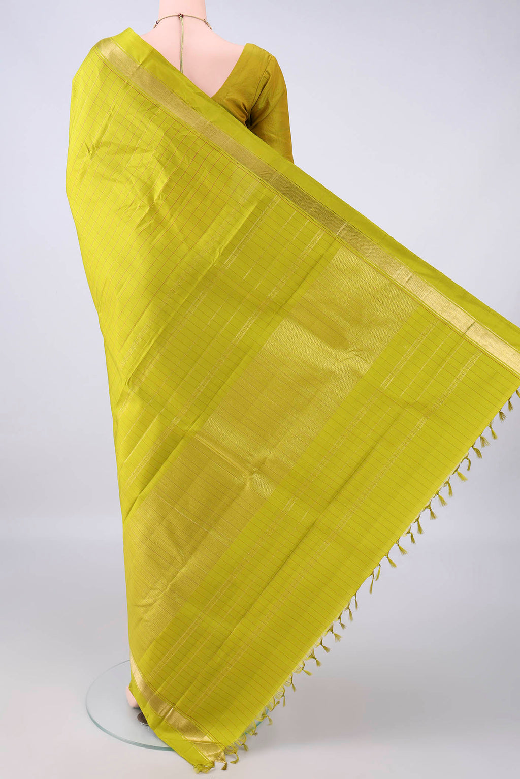 Flat view of Pure Silk Parrot Green Kanchipuram Saree with Checked design on the body and Zari Border. 