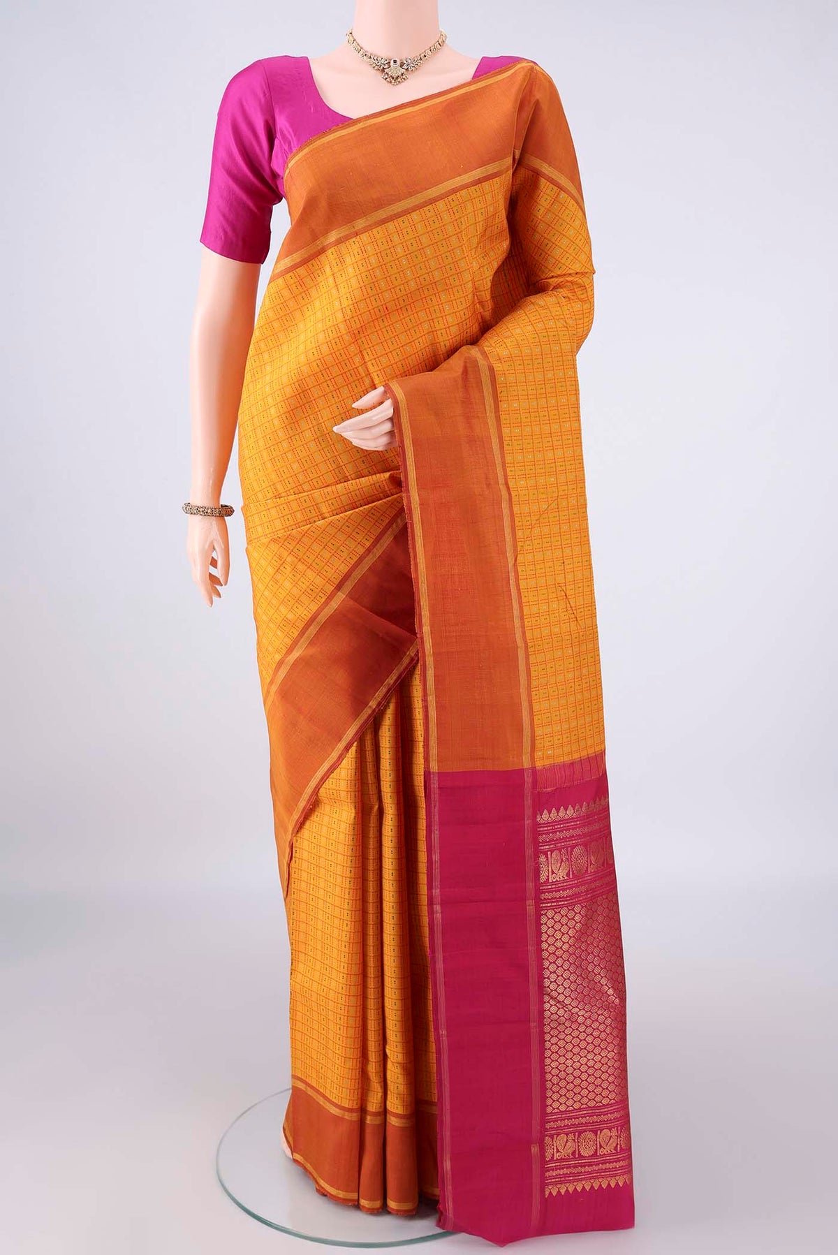 Pure Silk Yellow Kanchipuram Saree with Checked design on the body and Plain Border.  displayed on a mannequin
