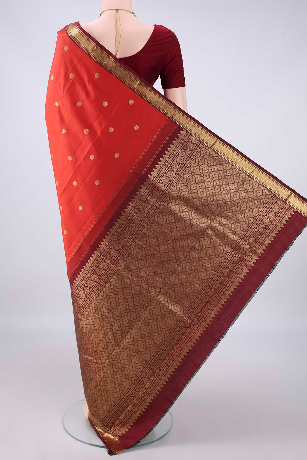 Flat view of Pure Silk Orange Kanjivaram Saree with Zari Butta on the body and Zari Border. 