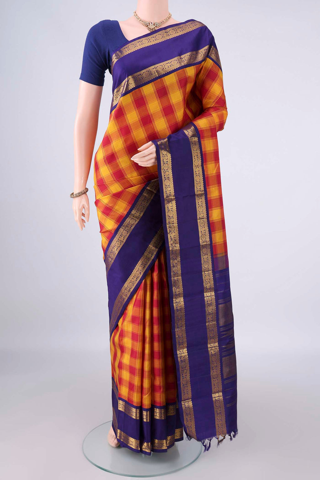 Pure Silk Multi Color Kanjivaram Saree with Checked design on the body and Zari Border.  displayed on a mannequin