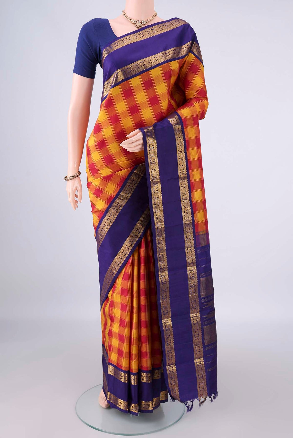 Pure Silk Multi Color Kanjivaram Saree with Checked design on the body and Zari Border.  displayed on a mannequin