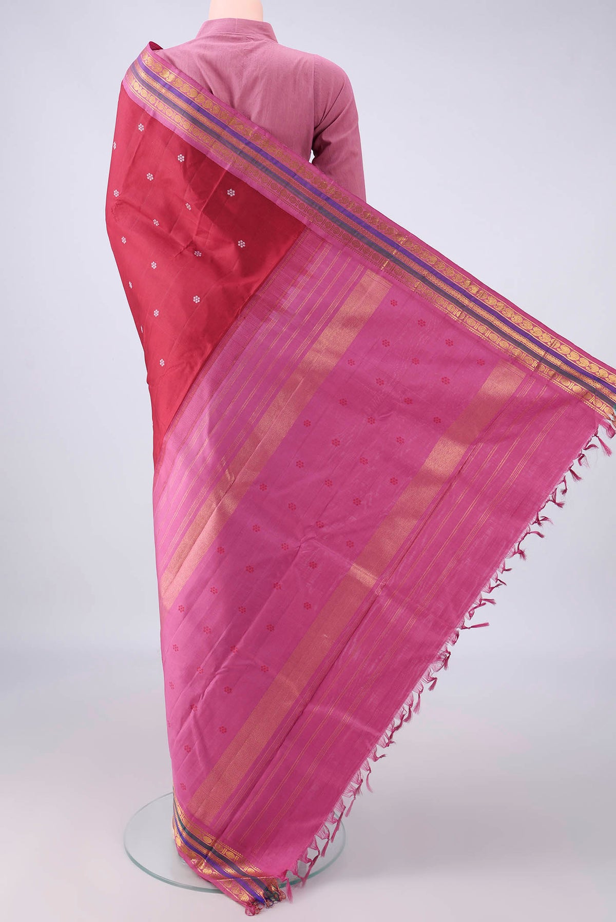 Flat view of Pure Silk Maroon Kanjivaram Saree with Thread Butta on the body and Zari Border. 
